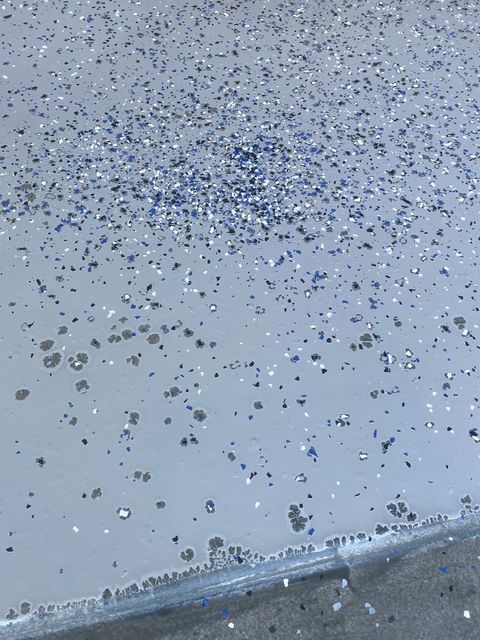 Second customer review photograph showing marks across the same grey garage coating